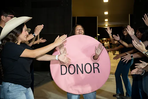 Woman in pink dot organ donation costume